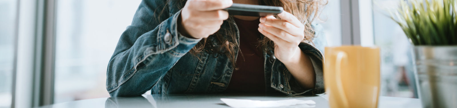 Woman depositing check with smart phone