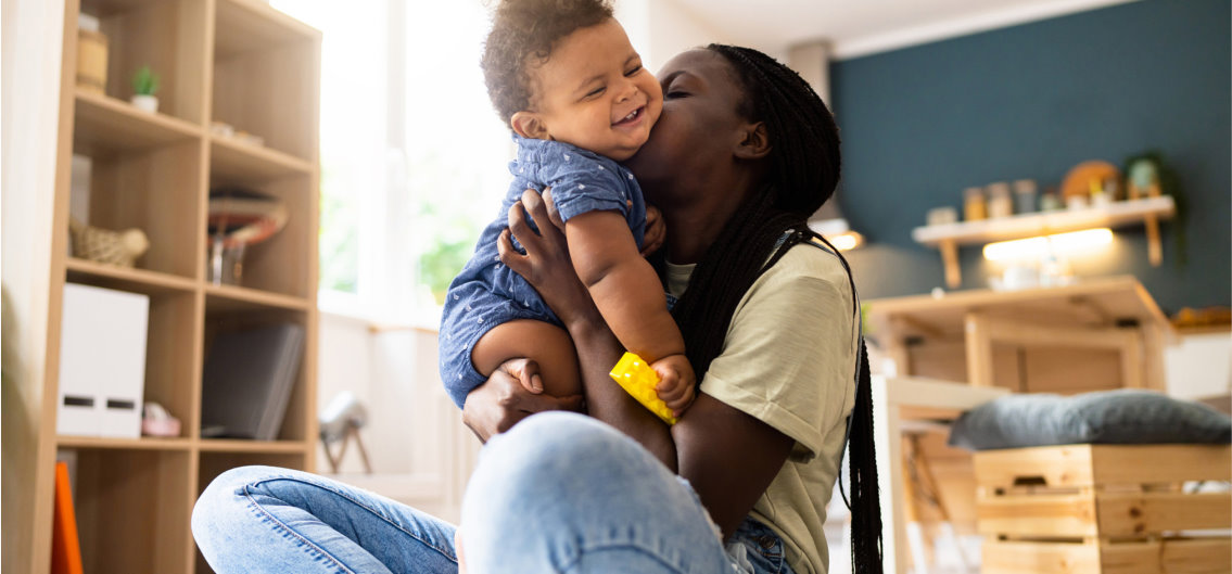 mom kissing baby on the cheek